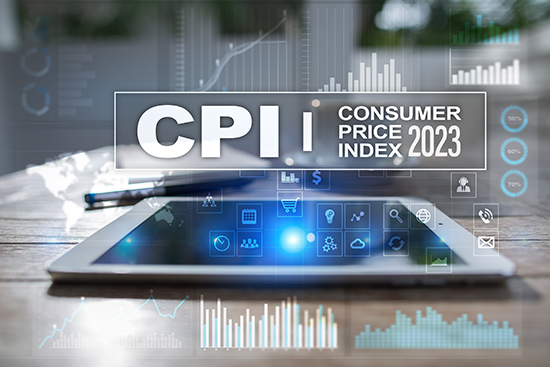 Laptop on table with chart images floating somewhat transparently around the image with the words CPI Conusmer Price Indes 2023 in white letters towards the top.