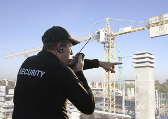 armed security guard pointing