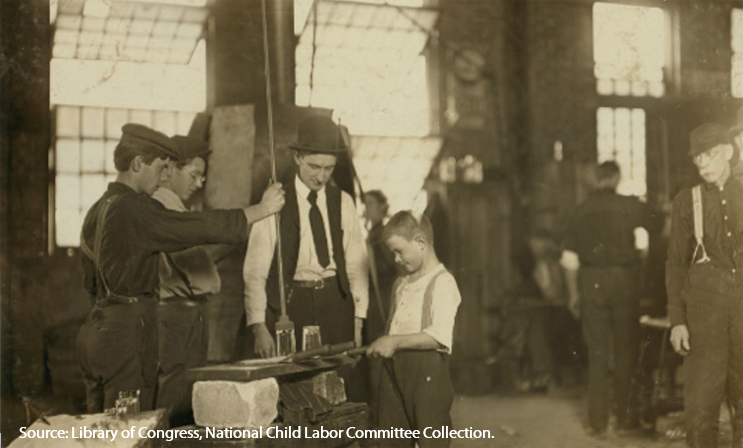 Glass factory employees teaching a young boy glass making, Morgantown, West Virginia, about 1908.