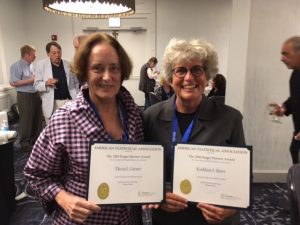 Thesia Garner and Kathleen Short holding their Roger Herriot Award certificates.
