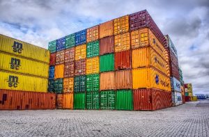 Shipping containers sitting on a dock at a port.