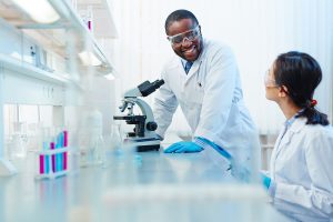 Two biochemists talking in a lab