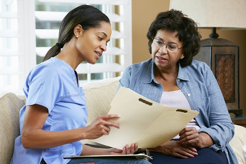 A nurse talking to a female patient