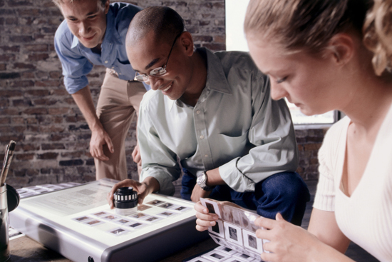 Photographers inspecting snapshots.