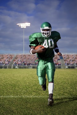 Football player running in a stadium