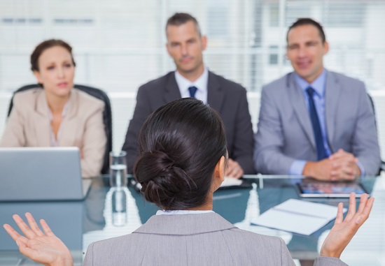 Woman being interviewed by 3 