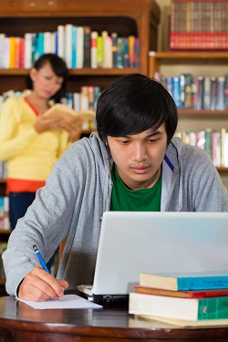 Young man researching in a library