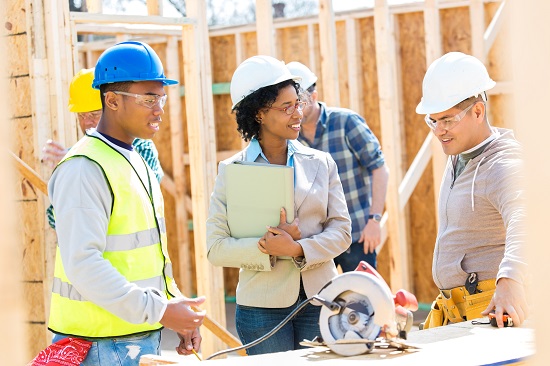 Construction workers building a house