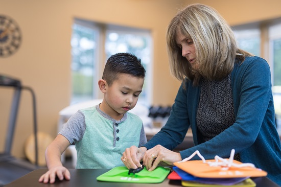 Occupational therapist working with a child