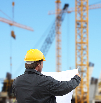 Man reading blueprints at a construction site