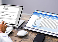 Person filling out job application online.
