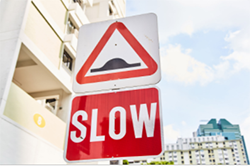 Street sign showing slow in red lettering. Decorative