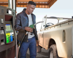 Man pumping gas at gas station