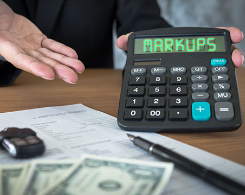 Car keys, contract, and calculator showing markups 