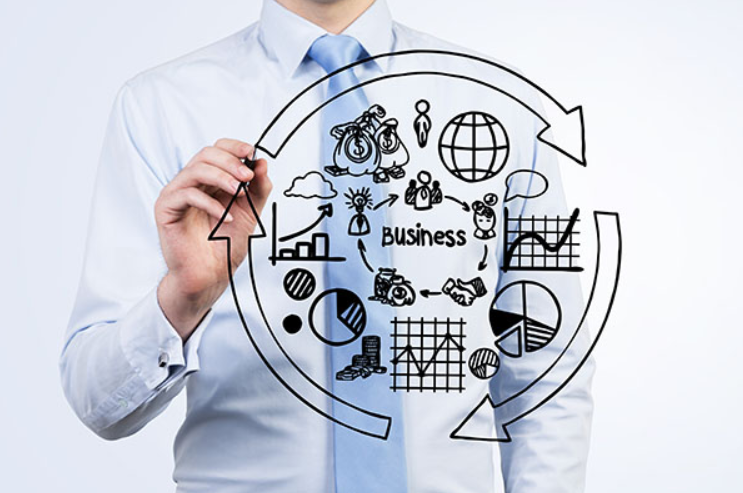 Person in a shirt and tie drawing business figures on a clear surface