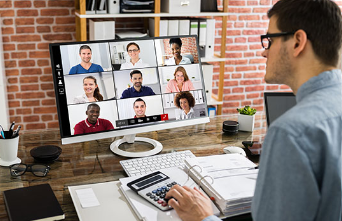 Remote worker in a meeting sitting at desk.