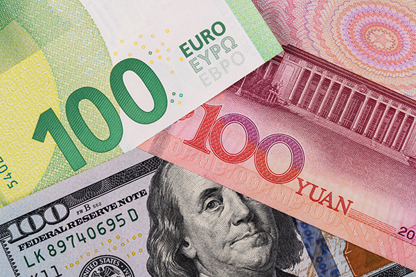 Overlapping currency of 100 euros, 100 dollars and 100 yuan. 