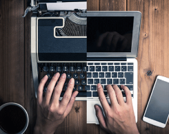 Split view of hands on typewriter and laptop computer