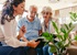 An older couple talks with a concierge who is assisting them with a hotel offer.