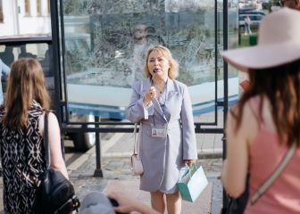 A tour guide using a microphone to speak to the group