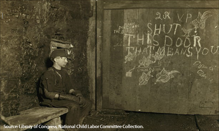 Boy sitting at mine entrance waiting to open door for coal car.