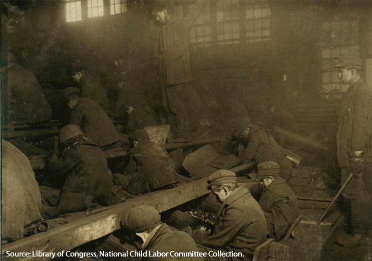 Several young boys working in coal mine in early 1930s amongst dust so thick that it obscured their vision.