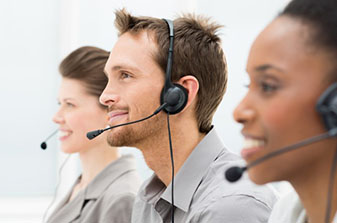 Two females and a male wearing headphones with a microphone.