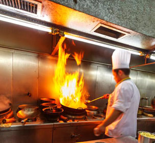 Chef cooking on stove in restaurant