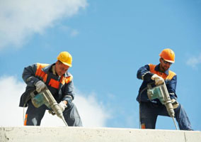 Construction workers using jackhammers