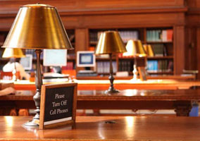 Sign posted inside a library asking patrons to turn off cell phones