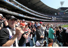 Fans cheering while at a stadium