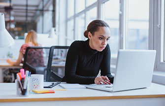 Female event planner working on a laptop.