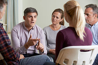 Group talking and sitting in a circle.