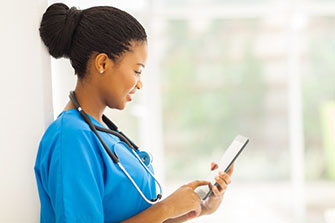 Nursing assistant using a tablet.