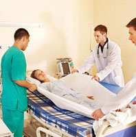 Hospital workers moving patient