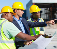 Construction workers discussing site plans