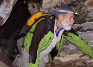 Man crawling in a cave