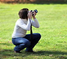 Woman crouching taking a picture