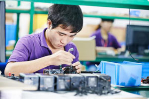 Worker repairing electronic equipment