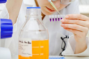 Laboratory worker filling specimen containers