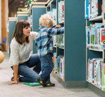 Women bending to work with child