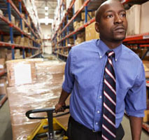 Worker pulling pallet on cart