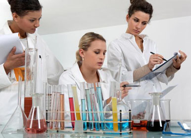 Workers in laboratory examining specimen jar