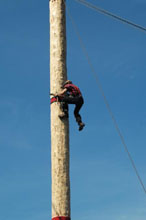 Worker climbing pole