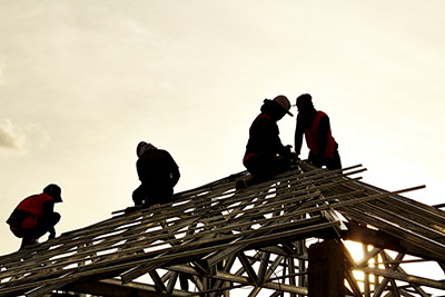 Workers building a roof
