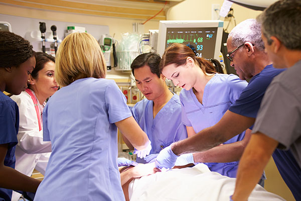 Healthcare professionals attending to a patient in the emergency room